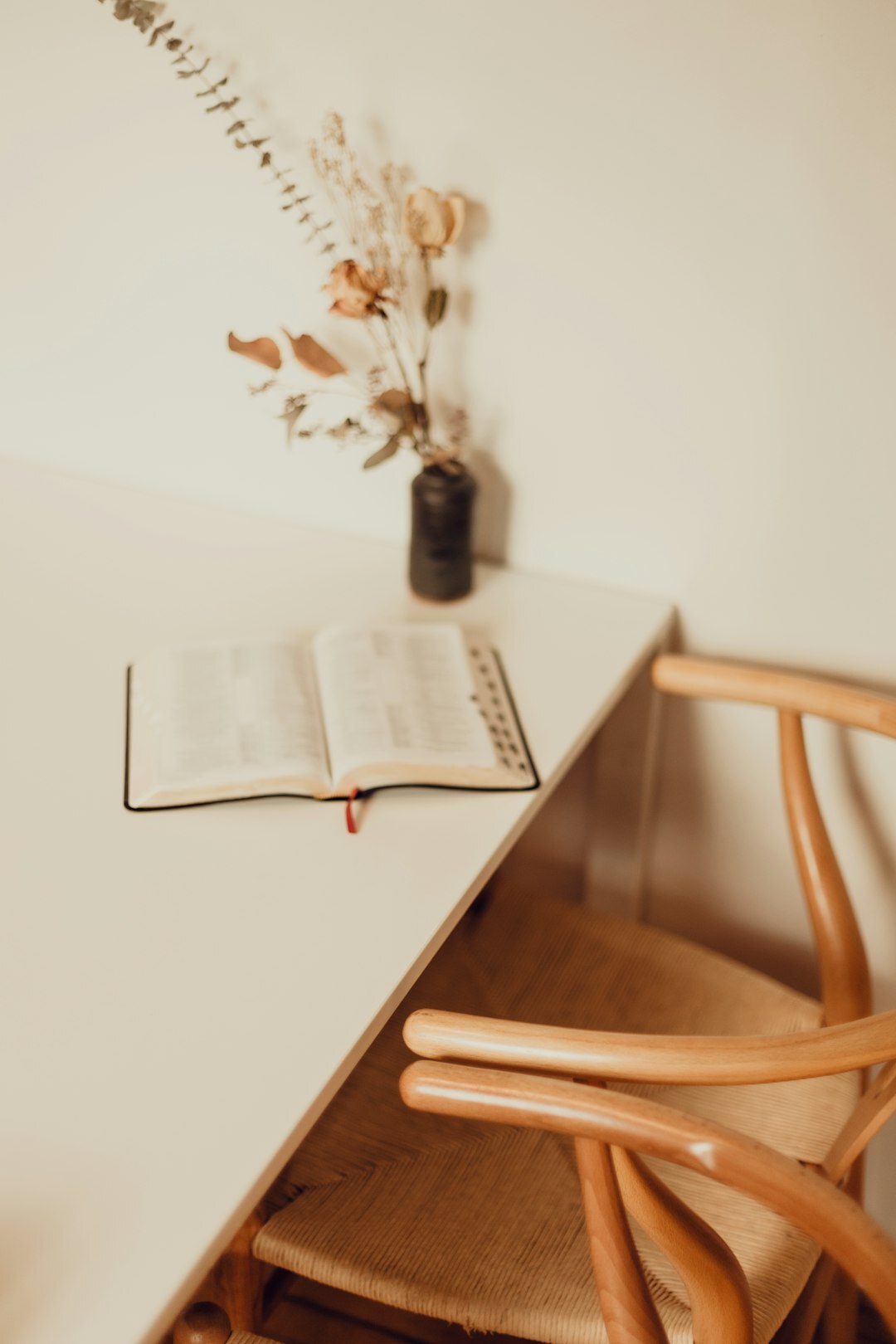 Quiet minimalist study with a desk, chair and bookshelf