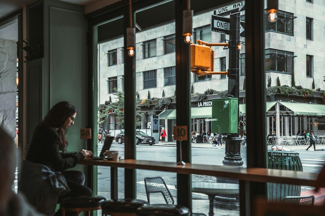 person alone in cafe with phone